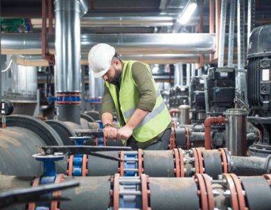 Engineer working on valve in factory or utility